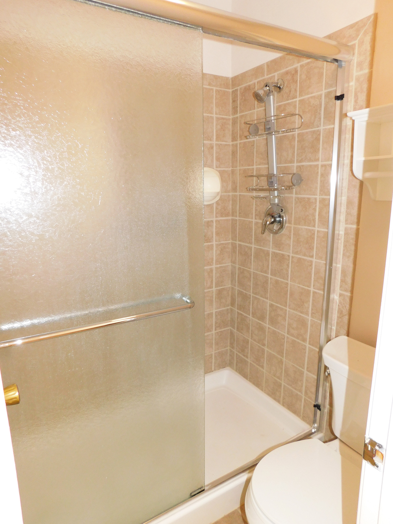 1191 Ranchview Court Buffalo Grove, IL 60089 - Photo 12 of 20 a bathroom with a shower and a toilet
