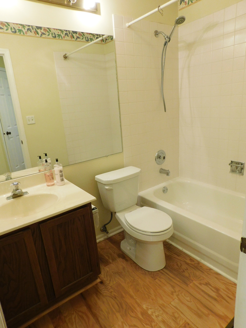 1191 Ranchview Court Buffalo Grove, IL 60089 - Photo 13 of 20 a bathroom with a sink toilet and shower