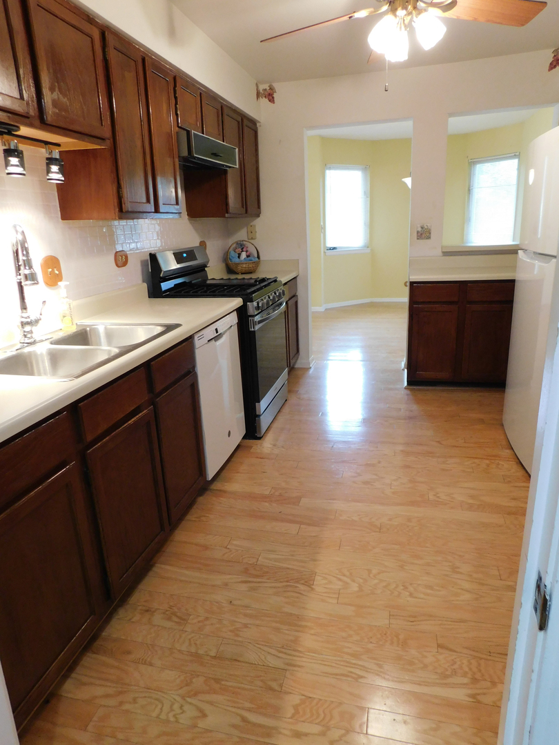 1191 Ranchview Court Buffalo Grove, IL 60089 - Photo 6 of 20 a kitchen with stainless steel appliances granite countertop a sink and a stove