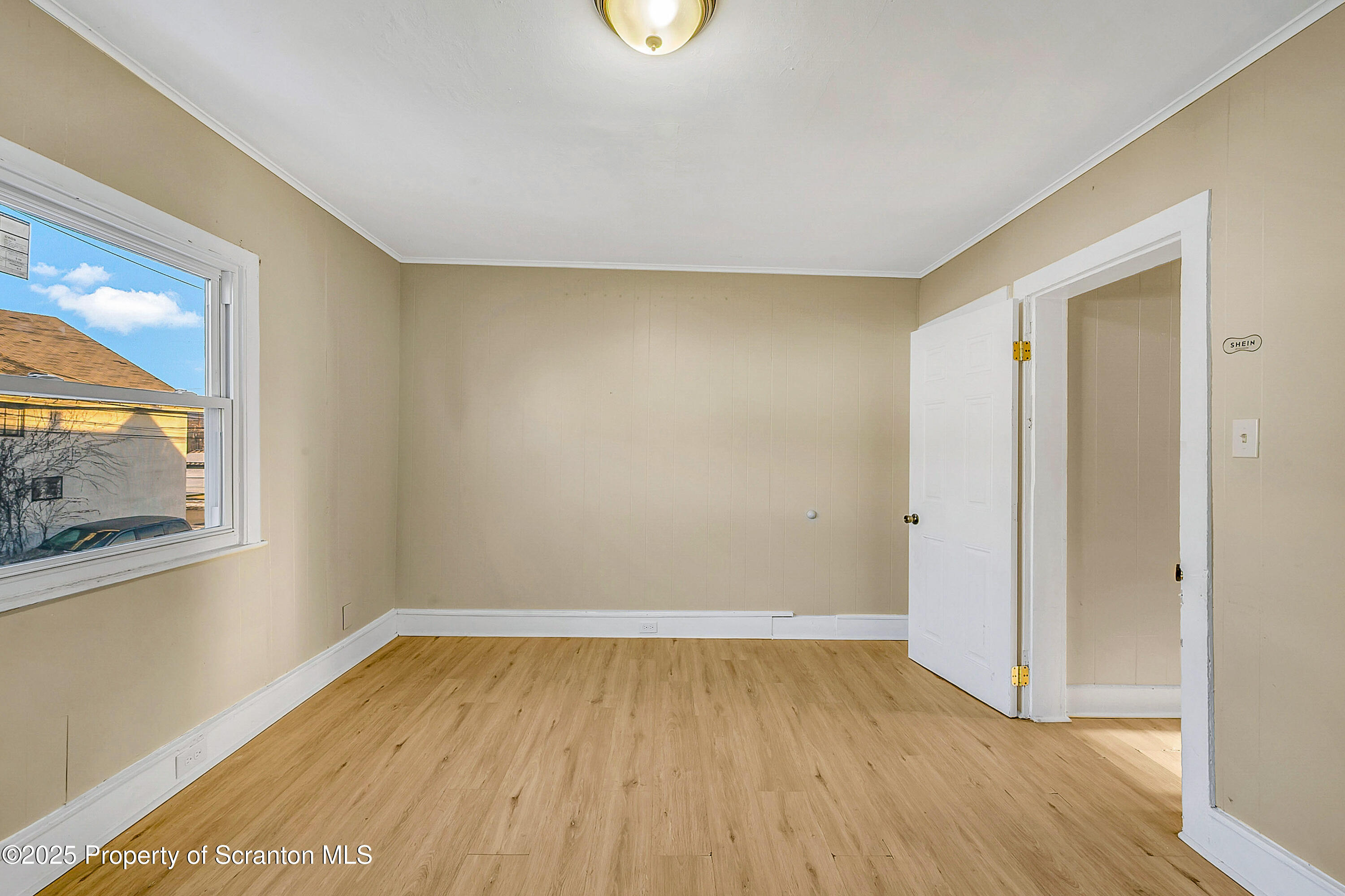1011 Washburn Street, Unit 2 Scranton, PA 18504 - Photo 3 of 12 a view of an empty room with wooden floor and a window