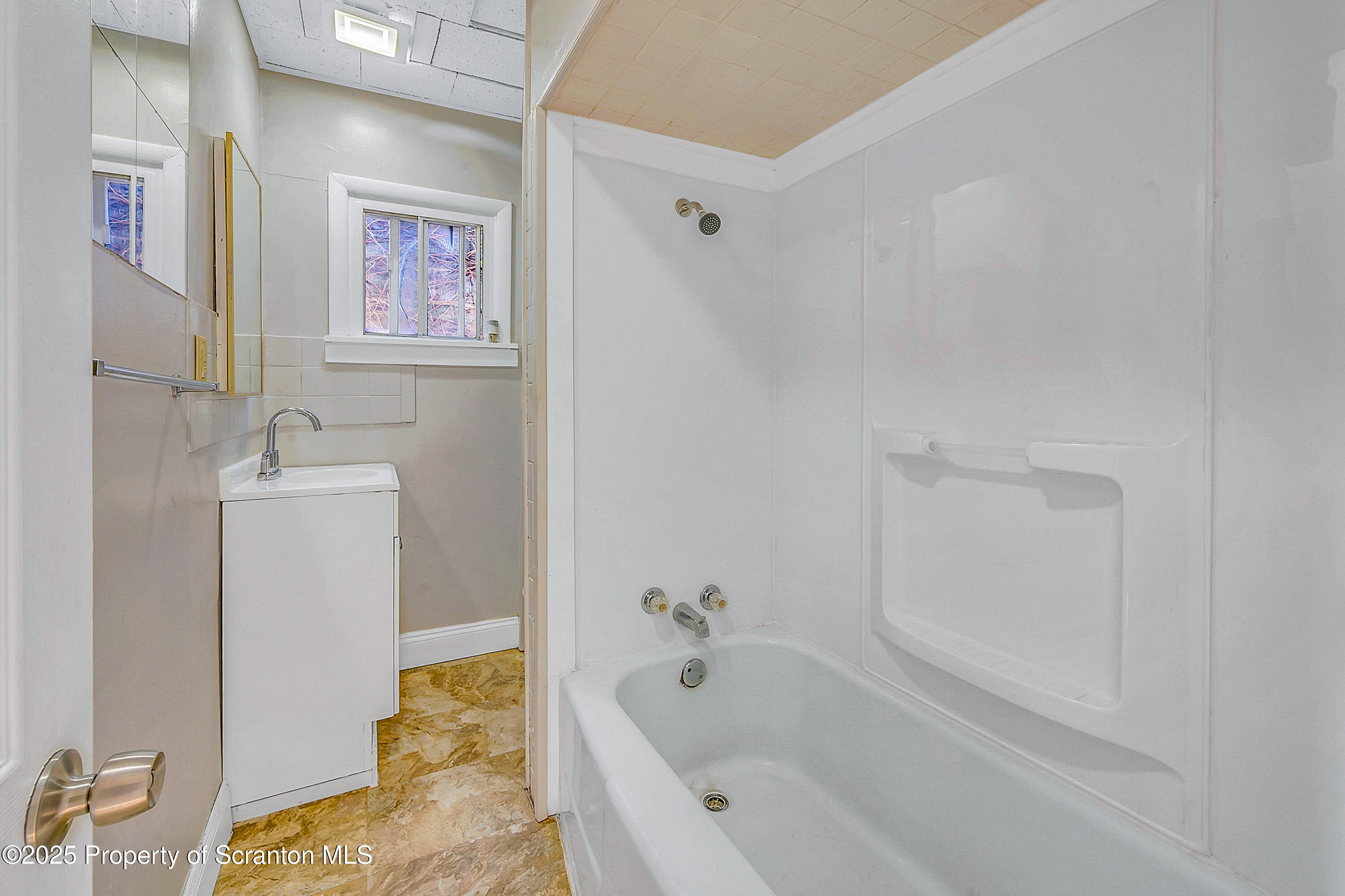 1011 Washburn Street, Unit 2 Scranton, PA 18504 - Photo 4 of 12 a bathroom with a tub sink and a mirror