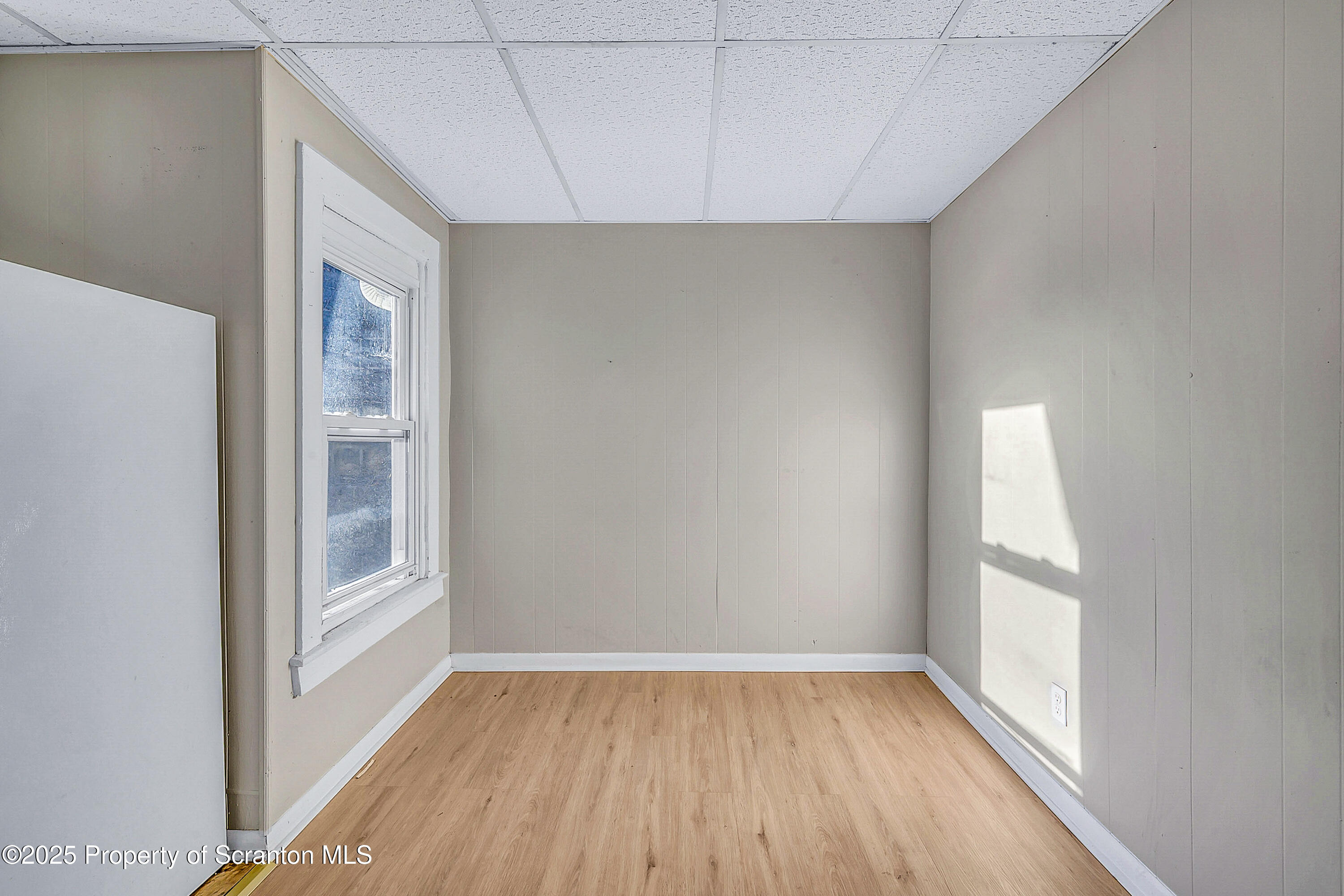 1011 Washburn Street, Unit 2 Scranton, PA 18504 - Photo 5 of 12 a view of an empty room with wooden floor and a window