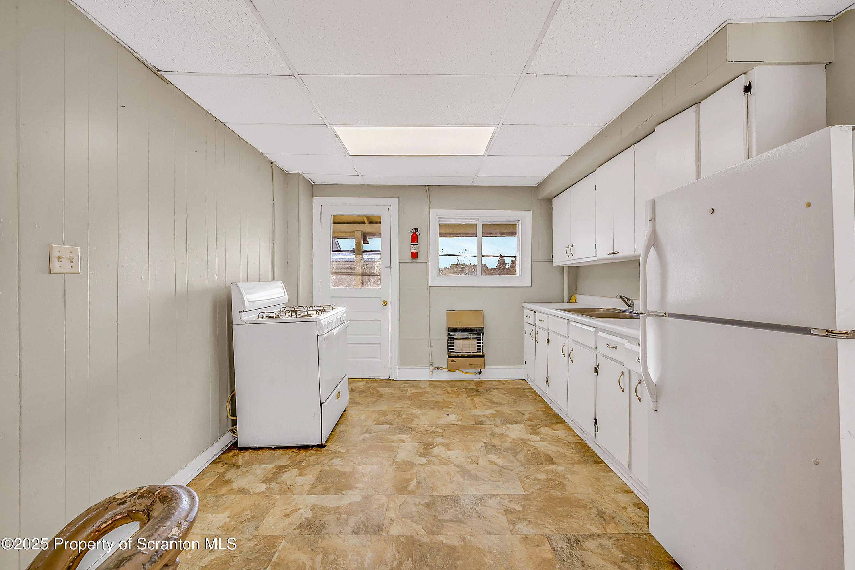 1011 Washburn Street, Unit 2 Scranton, PA 18504 - Photo 6 of 12 a kitchen with sink cabinets and white appliances