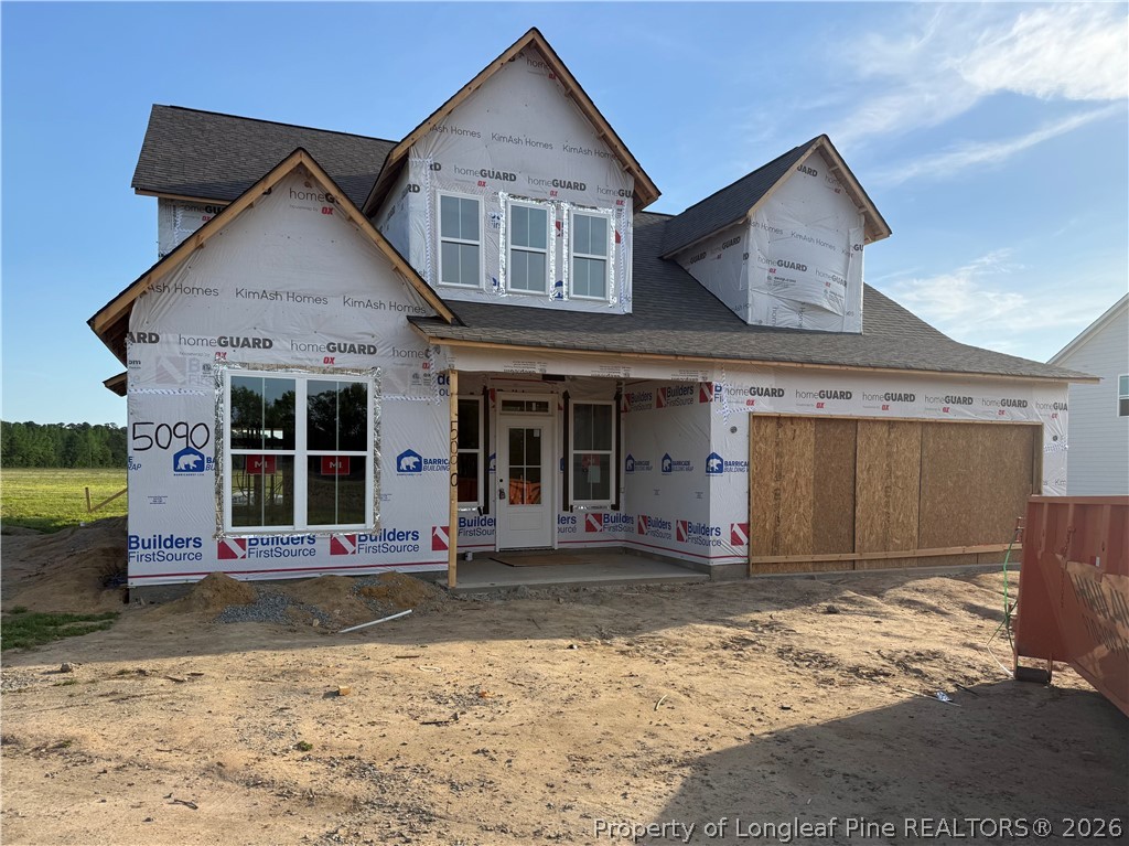 5090 Ross West Road Dunn, NC 28334 - Photo 4 of 15 a front view of a house with a yard and garage