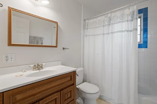 a bathroom with a sink toilet and a mirror