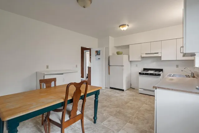a kitchen with stainless steel appliances kitchen island a refrigerator and a stove top oven