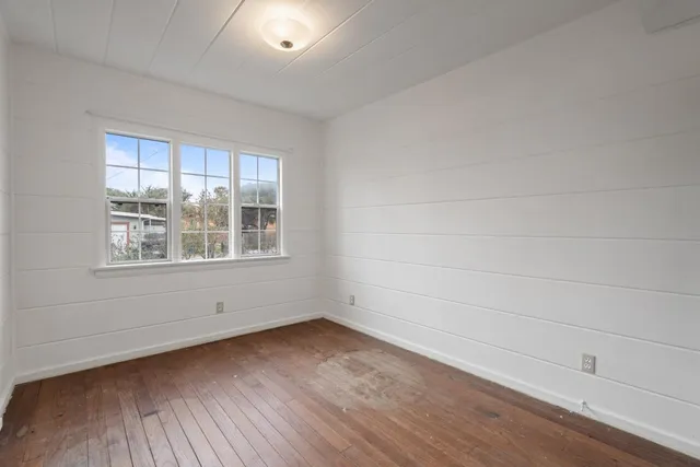 wooden floor in an empty room with a window