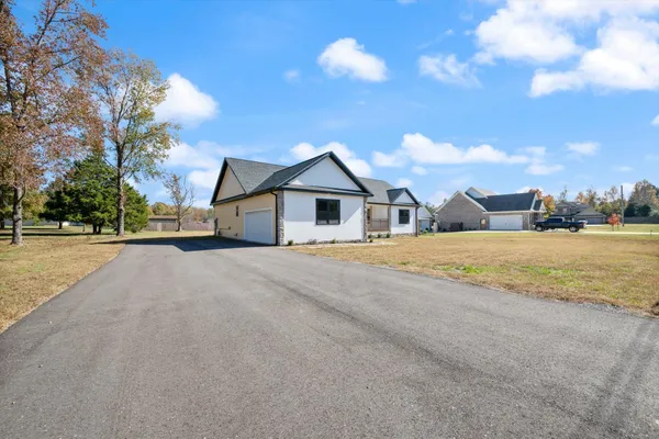 a view of house with yard and ocean view