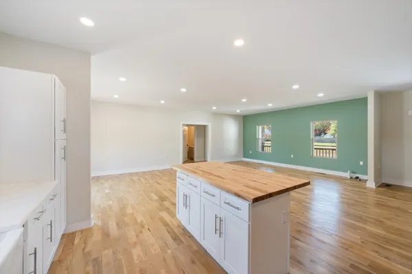 a kitchen with a sink and wooden floor