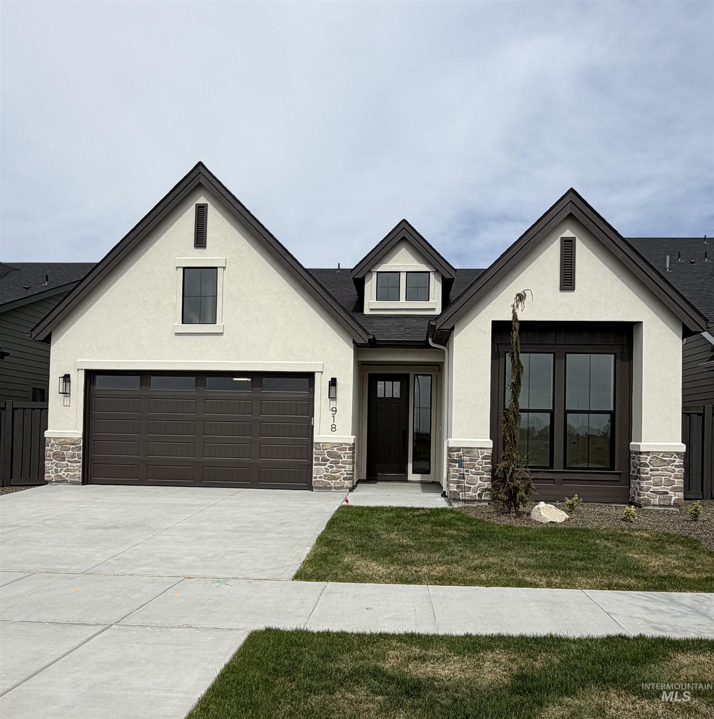 918 East Escalation Street Meridian, ID 83642 - Photo 1 of 30 View of front of house featuring stone siding and stucco siding