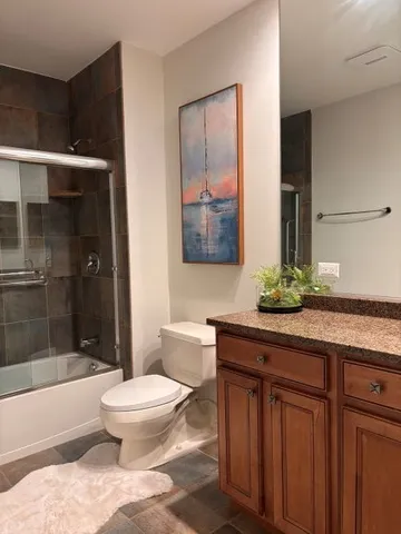 a bed sitting in a spacious bedroom next to a window