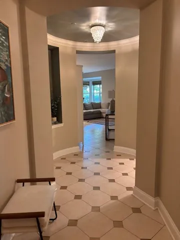 a view of a livingroom with wooden floor and a refrigerator