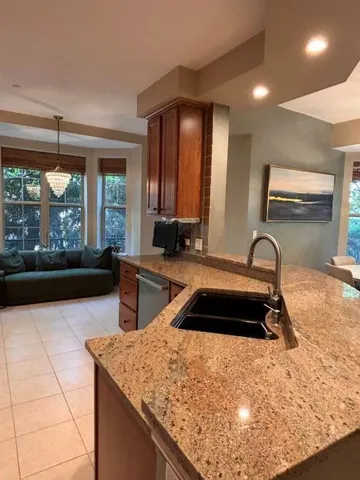 a kitchen with a sink and a large window