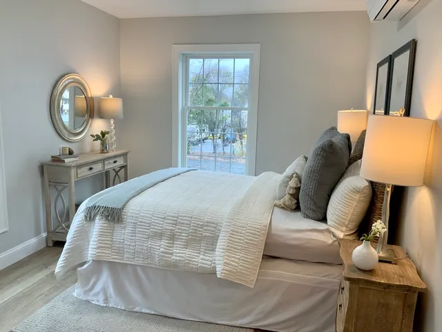 a living room with furniture and a mirror