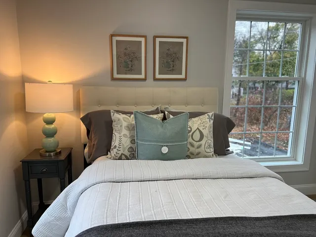 a bedroom with a bed and window