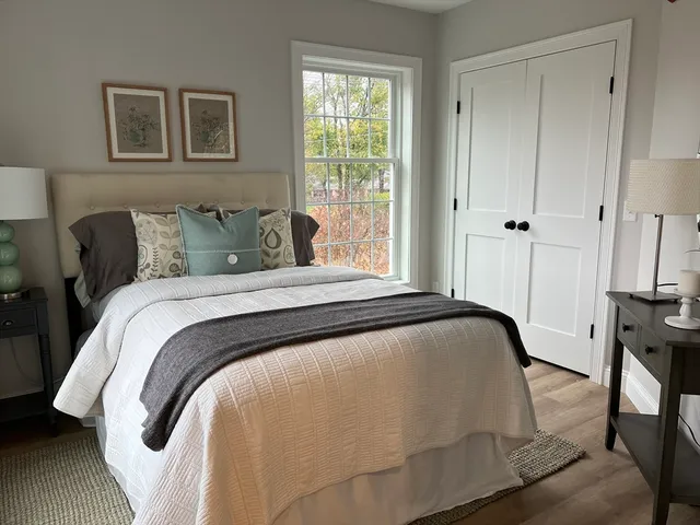 a bedroom with a bed and wooden floor