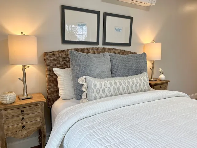 a bedroom with a bed and lamp