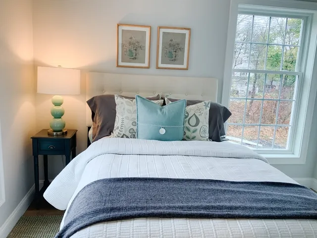 a bedroom with a bed and window