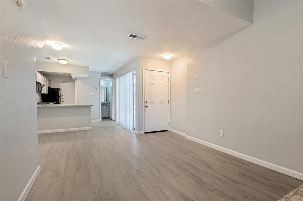 622 West Union Bower Road Irving, TX 75061 - Photo 9 of 13 Open concept living area featuring wood-finish flooring, light gray wall paint, and white baseboards