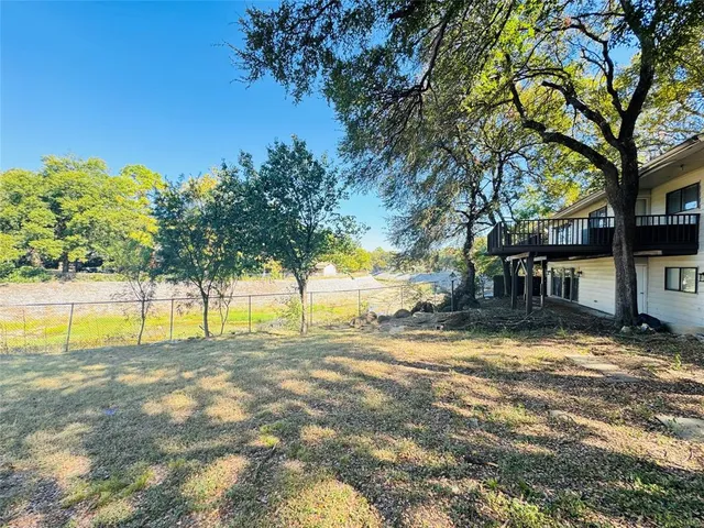 a view of a house with swimming pool and a big yard