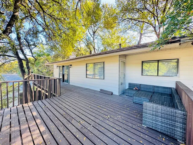 a view of backyard with deck and wooden floor