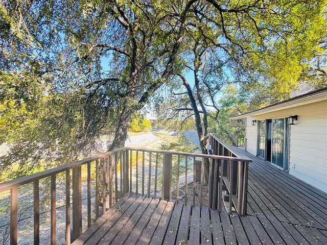 a view of balcony with wooden floor and fence