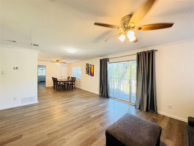 a view of a livingroom with furniture and hardwood floor