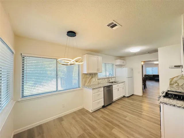 a kitchen with a stove a sink and a refrigerator
