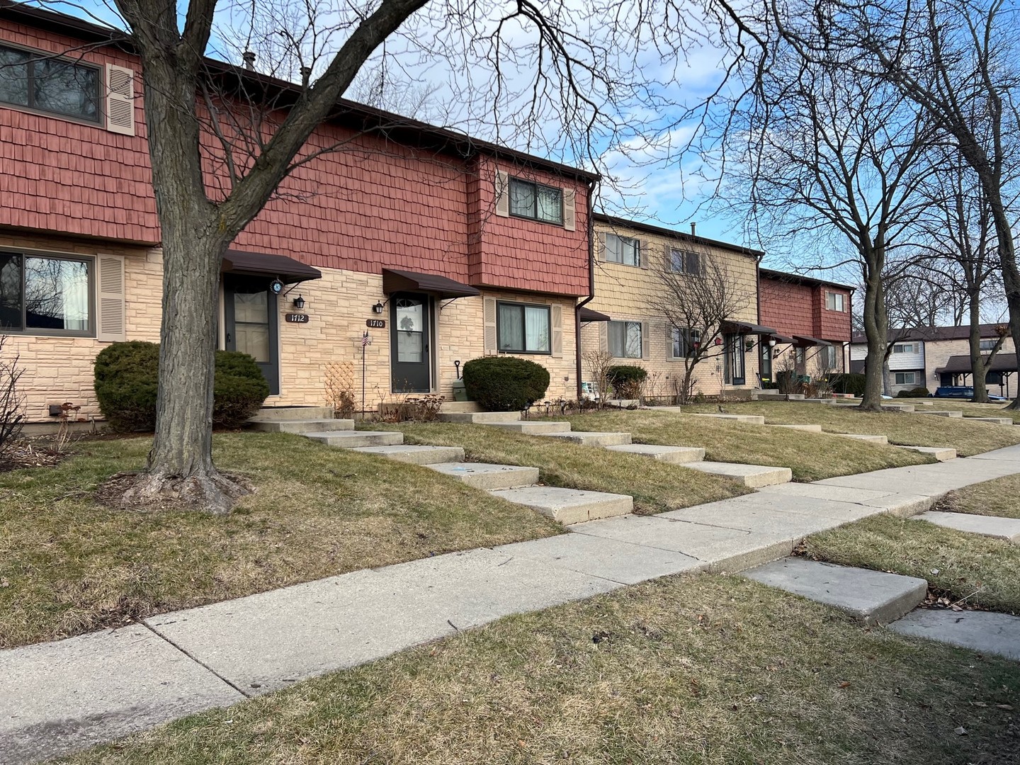 a front view of a building with a garden