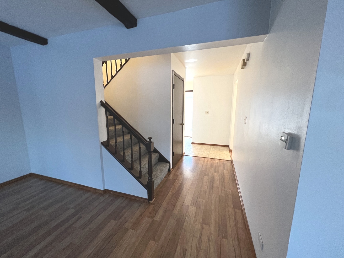 1706 Lakeview Drive Wheeling, IL 60090 - Photo 4 of 14 a view of a hallway with wooden floor and staircase