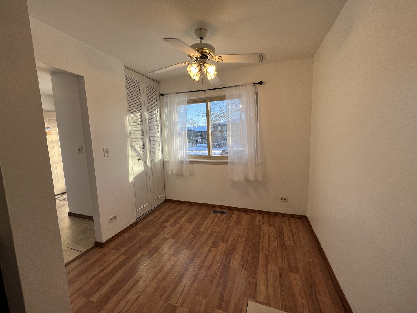 1706 Lakeview Drive Wheeling, IL 60090 - Photo 5 of 14 a view of an empty room with wooden floor and a window
