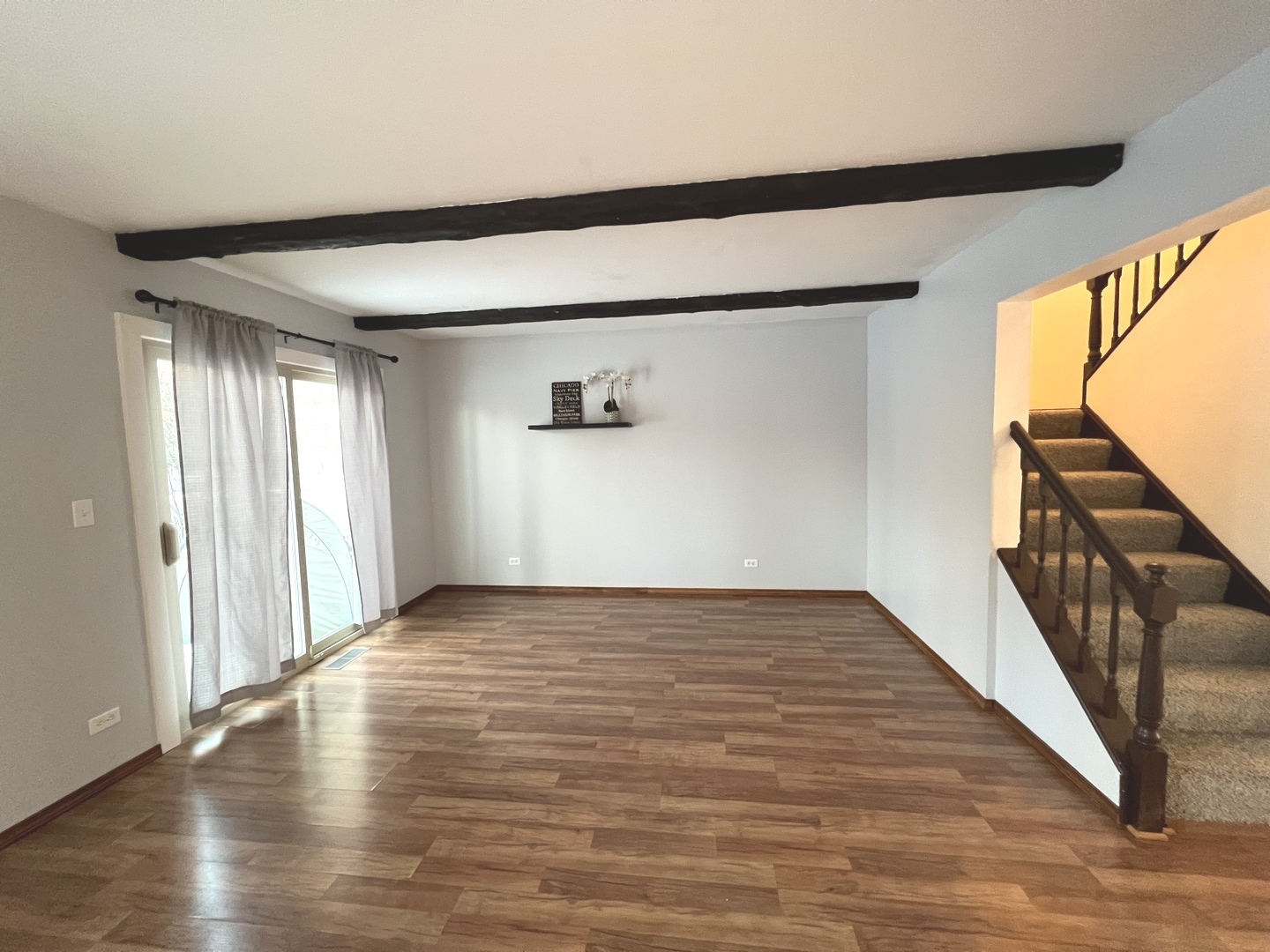 1706 Lakeview Drive Wheeling, IL 60090 - Photo 8 of 14 a view of an empty room with wooden floor and a window