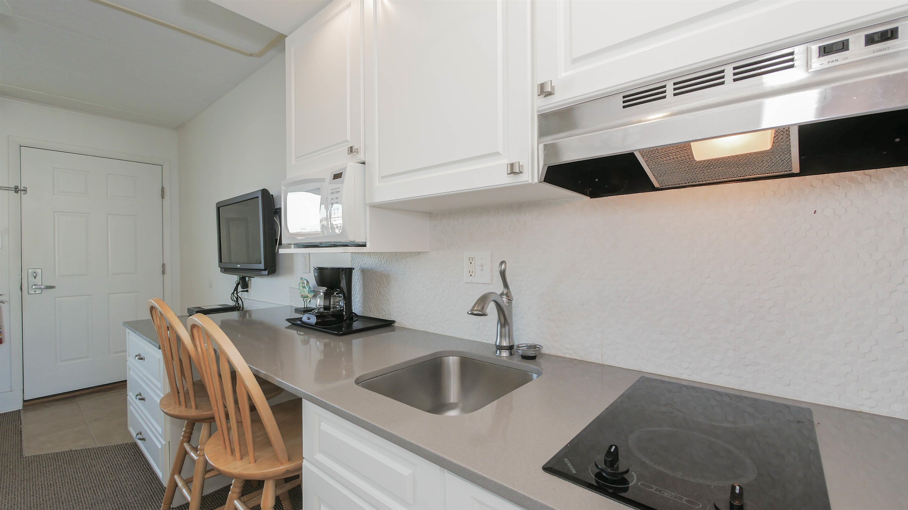 7800 Dune Drive, Unit 209 Avalon, NJ 08202 - Photo 11 of 21 a kitchen with a sink and a refrigerator
