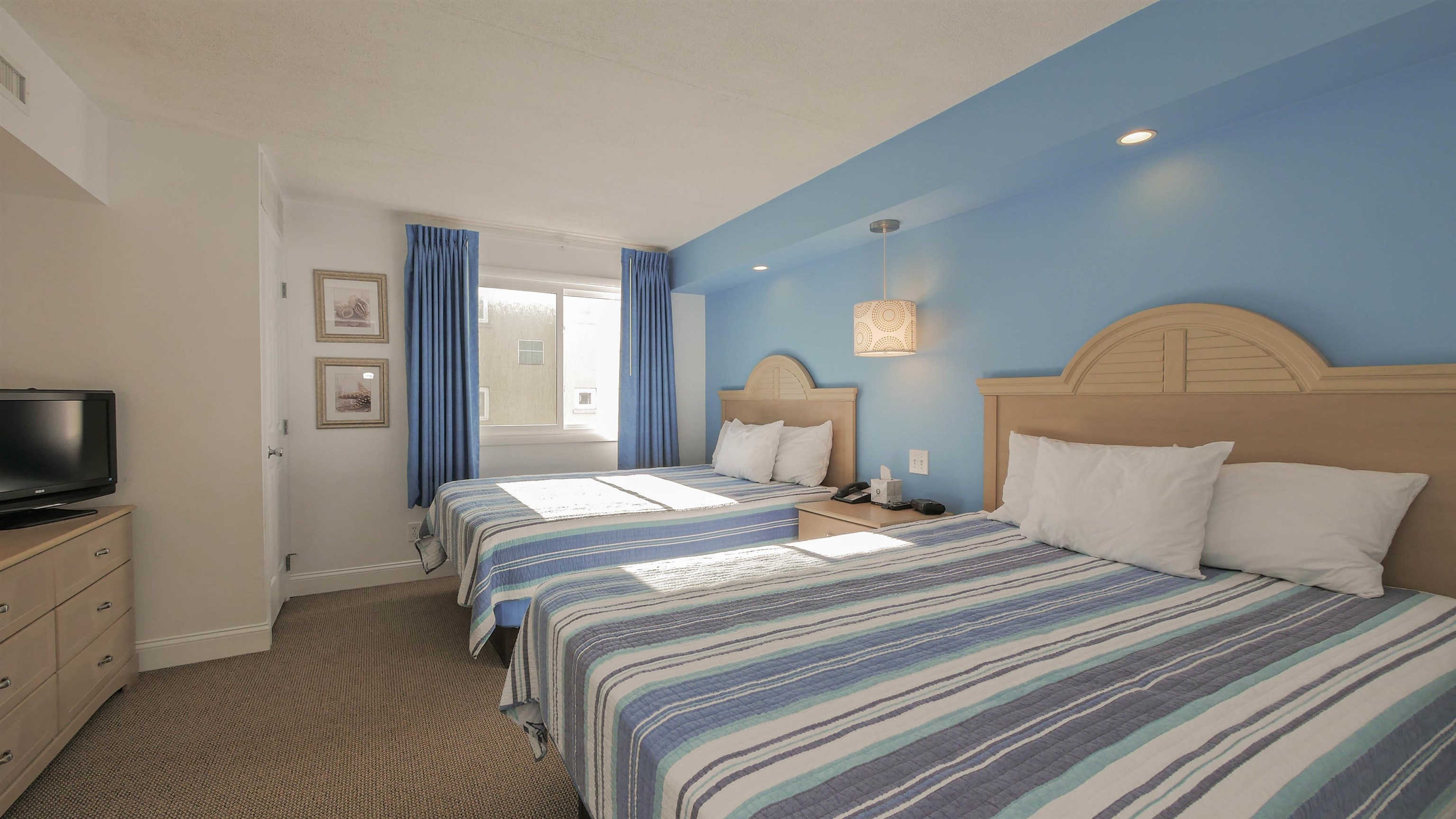 7800 Dune Drive, Unit 209 Avalon, NJ 08202 - Photo 15 of 21 a bedroom with a bed and a flat screen tv