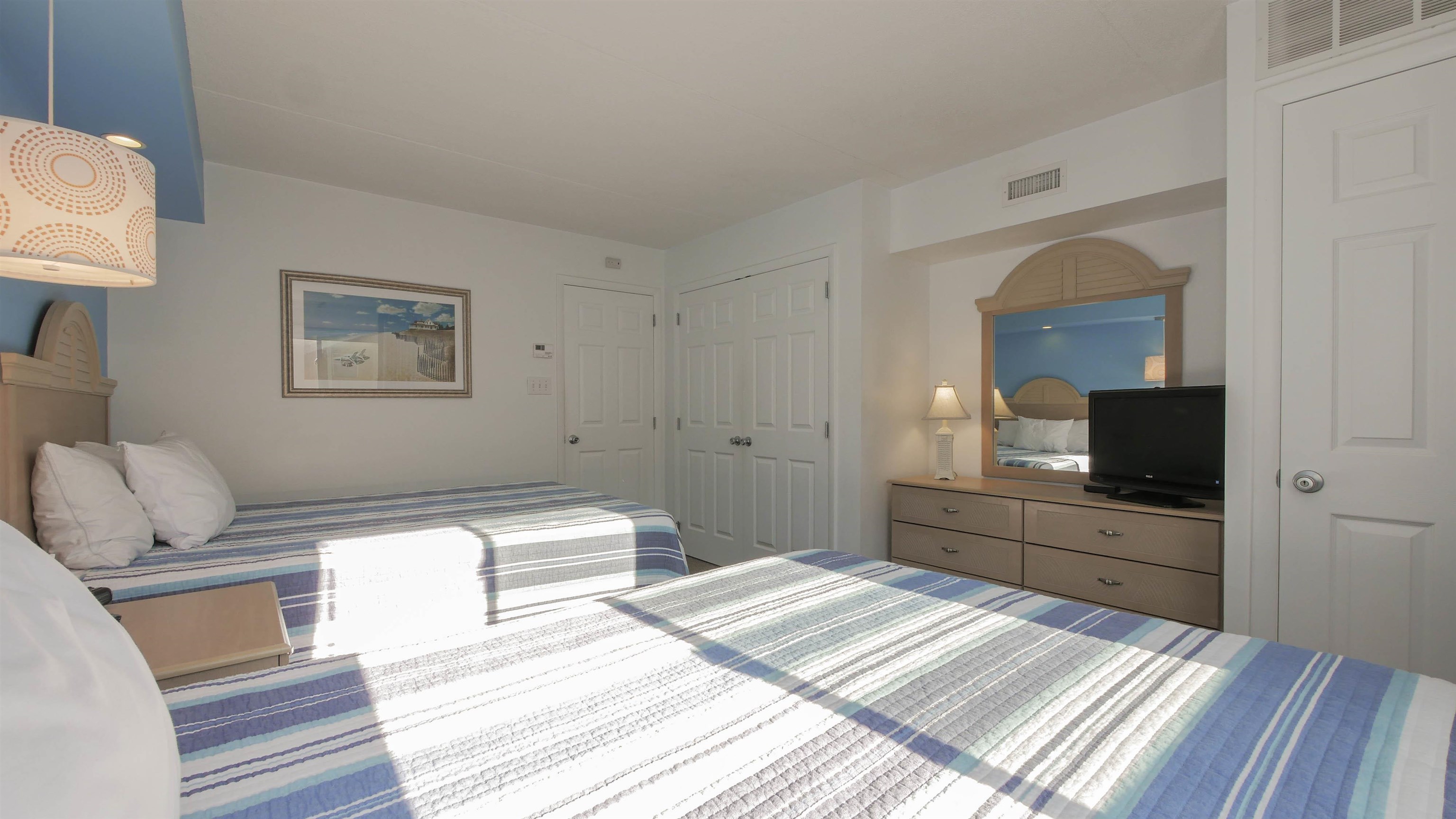 7800 Dune Drive, Unit 209 Avalon, NJ 08202 - Photo 17 of 21 a bedroom with a bed and a flat screen tv