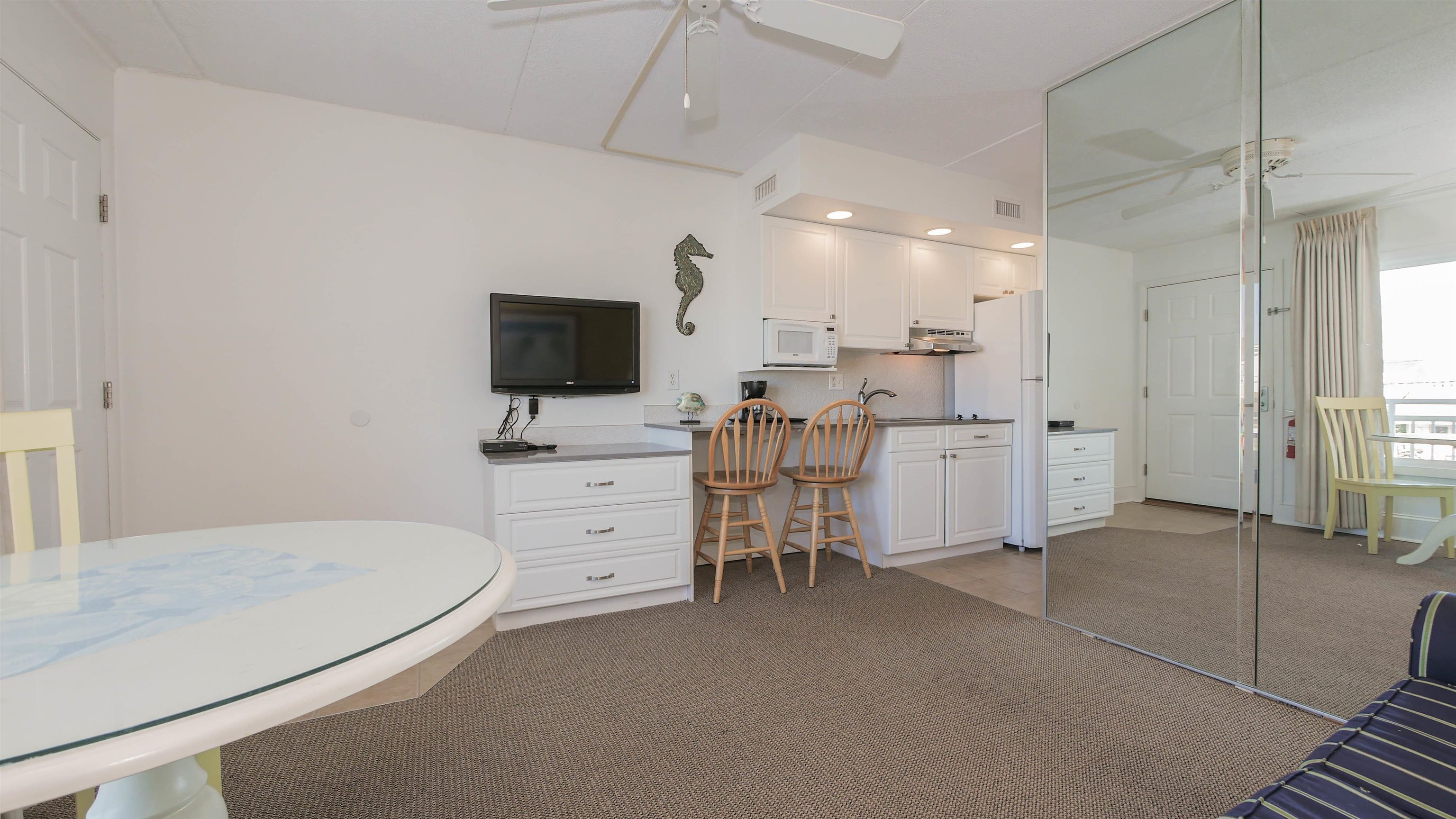 7800 Dune Drive, Unit 209 Avalon, NJ 08202 - Photo 8 of 21 a room with furniture and flat screen tv