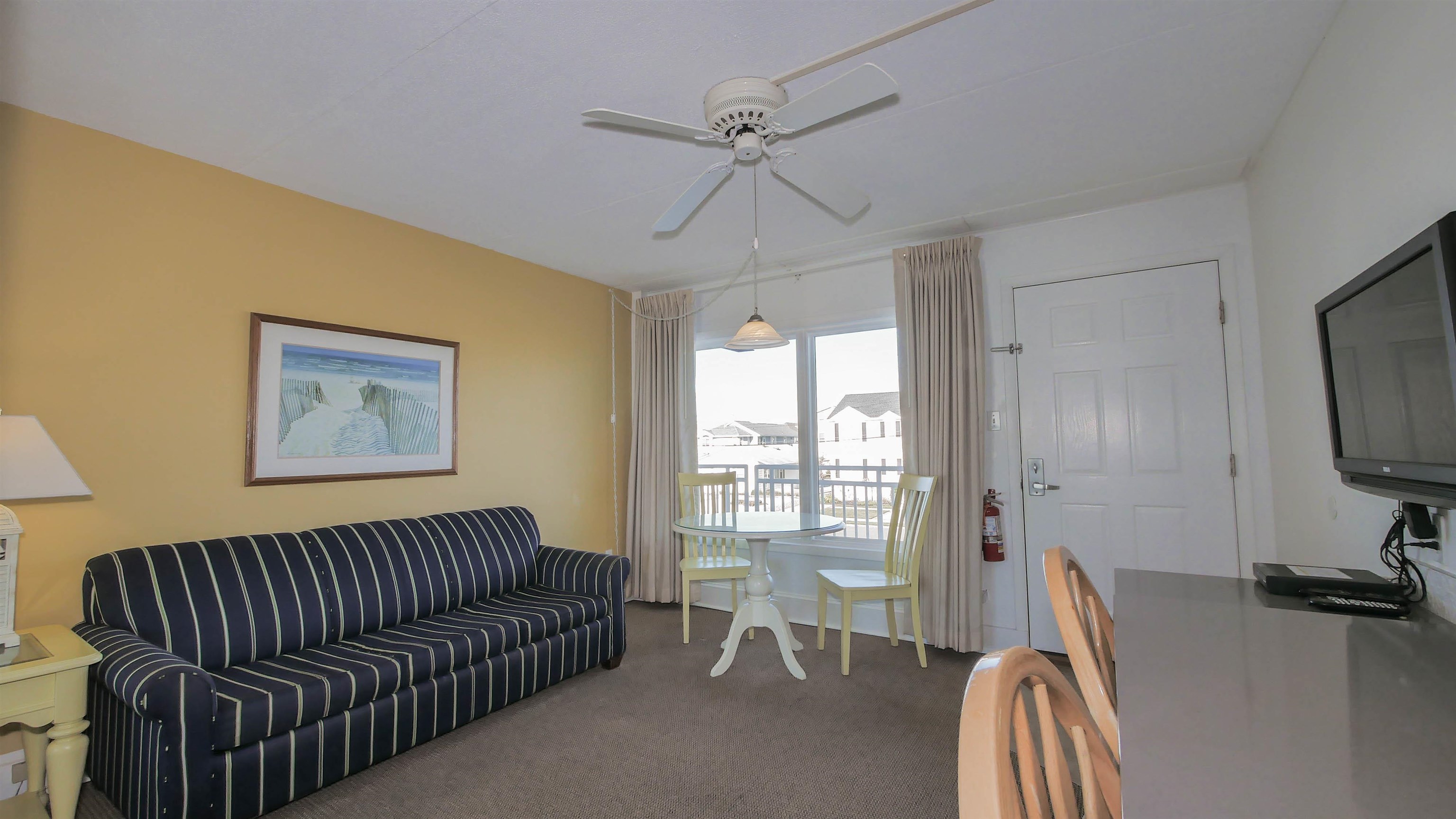 7800 Dune Drive, Unit 209 Avalon, NJ 08202 - Photo 9 of 21 a view of a livingroom with furniture and a ceiling fan