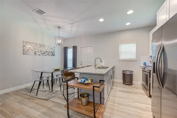 a view of a kitchen with a table and chairs