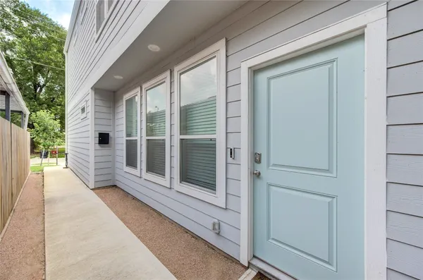 a view of a porch with a floor to ceiling window and wooden floor