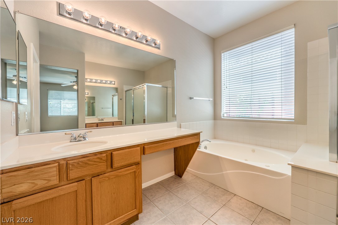 3713 Spring Shadow Road Las Vegas, NV 89129 - Photo 23 of 37 Relax and unwind in this primary bathroom, offering a soaking tub, dual vanity, and abundant natural light.