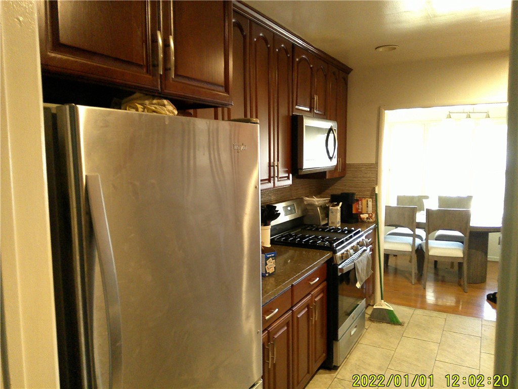 1505 West 136th Street Compton, CA 90222 - Photo 5 of 6 a kitchen with stainless steel appliances granite countertop a refrigerator and a stove