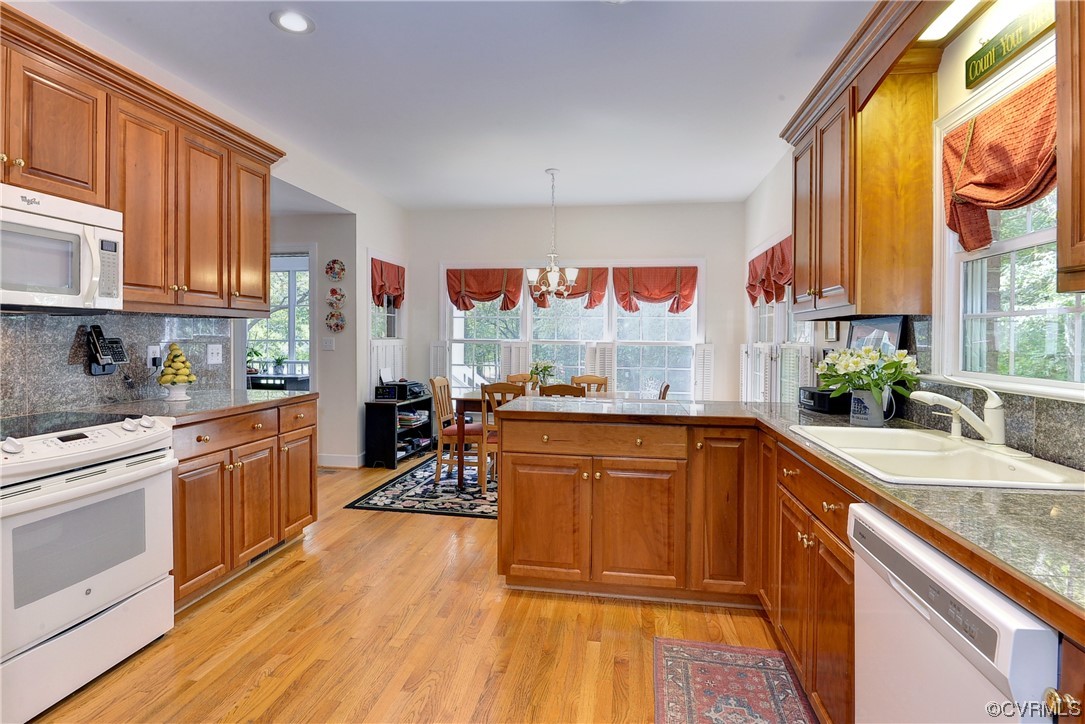 109 Butler Williamsburg, VA 23188 - Photo 11 of 47 a kitchen with stainless steel appliances granite countertop wooden cabinets a stove a sink and a large window