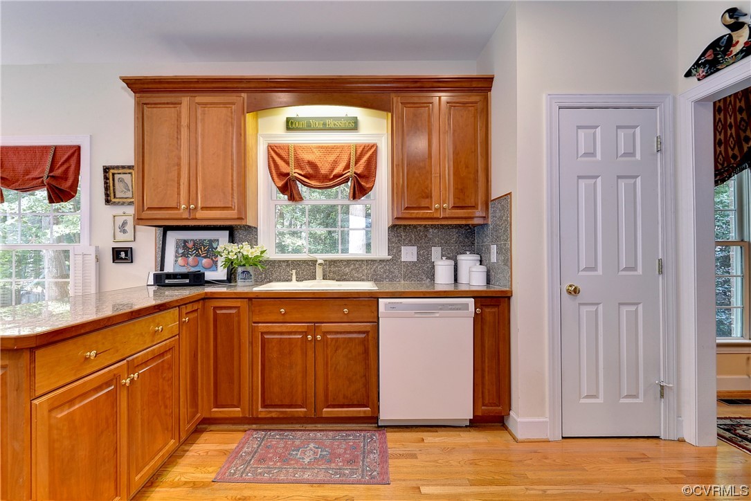 109 Butler Williamsburg, VA 23188 - Photo 12 of 47 a kitchen with stainless steel appliances granite countertop wooden cabinets a sink and a window