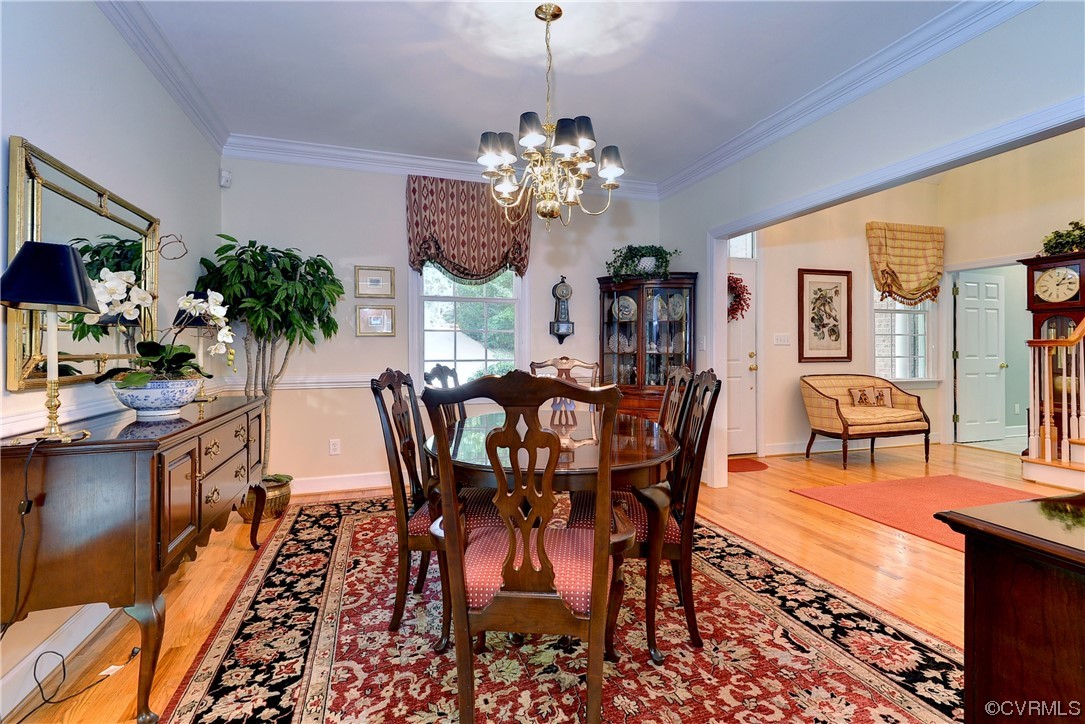 109 Butler Williamsburg, VA 23188 - Photo 14 of 47 a view of a dining room with furniture a chandelier and wooden floor
