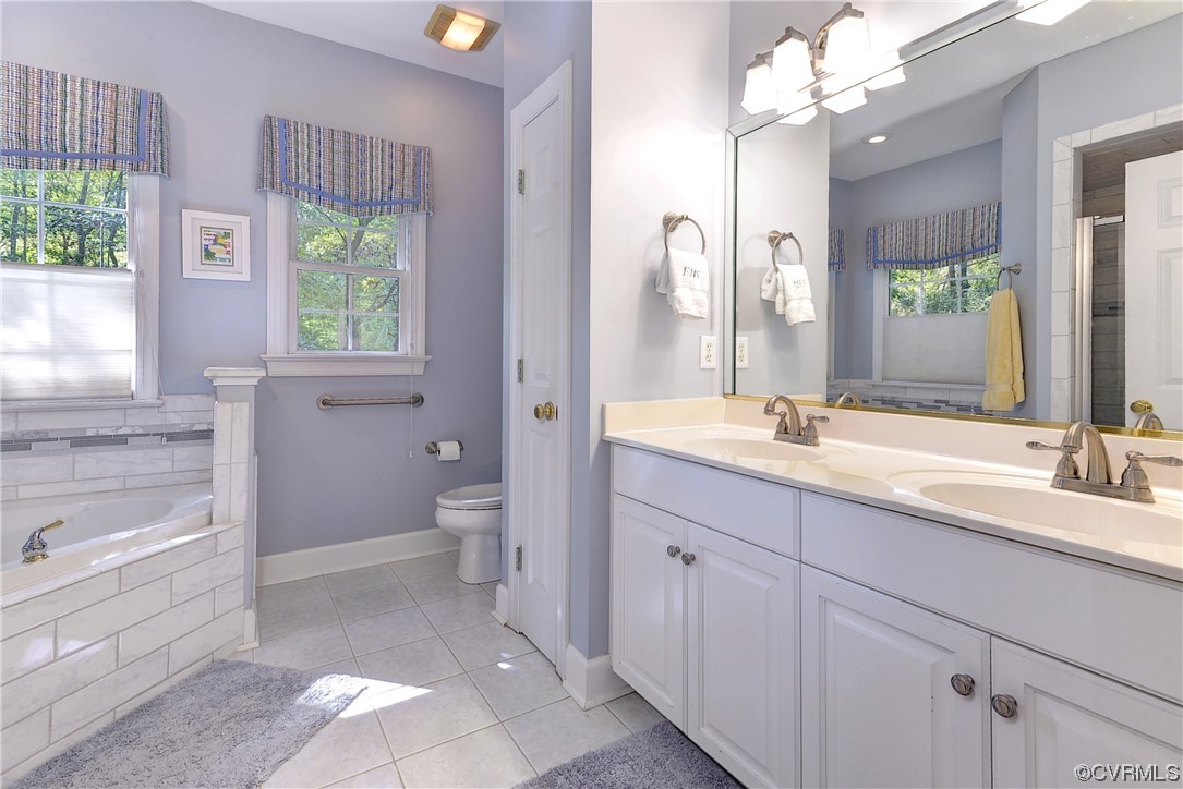 109 Butler Williamsburg, VA 23188 - Photo 18 of 47 a spacious bathroom with a granite countertop sink a large mirror a bathtub and next to a window