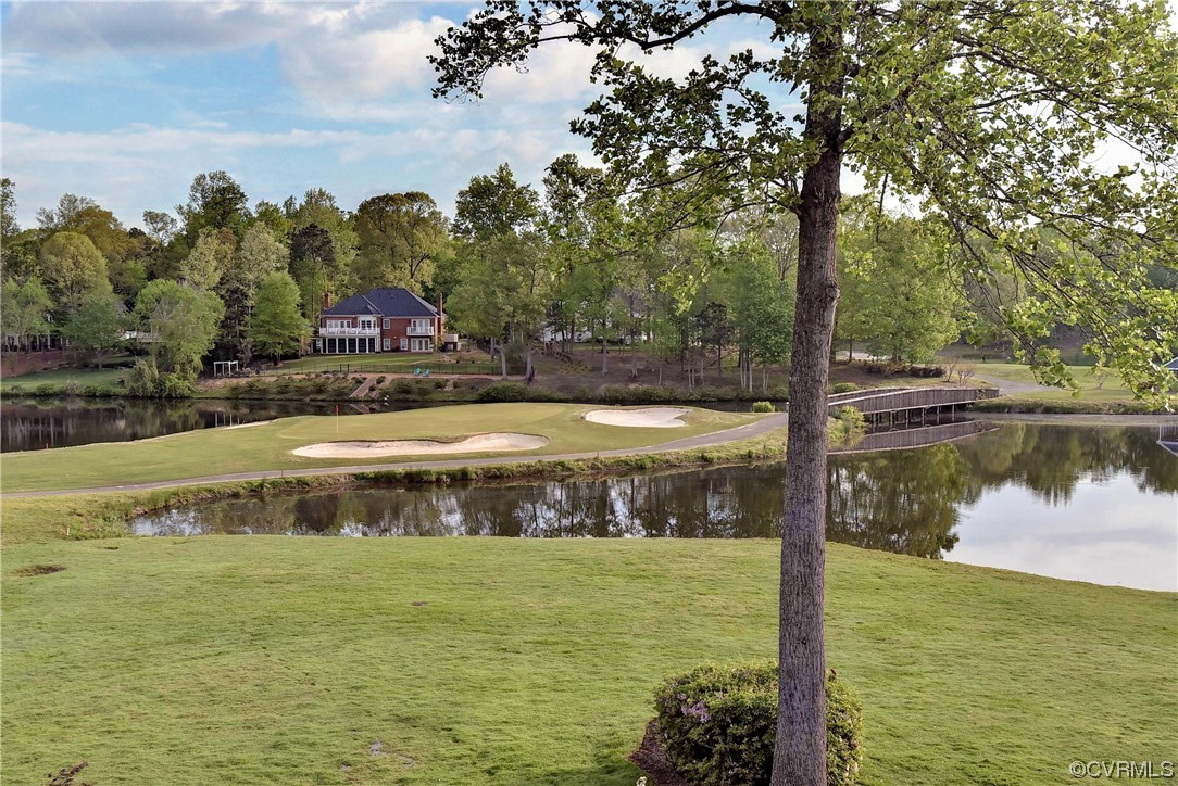 109 Butler Williamsburg, VA 23188 - Photo 42 of 47 a view of a swimming pool next to a lake with houses