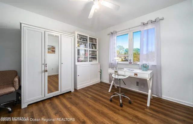 a workspace with wooden floor and windows