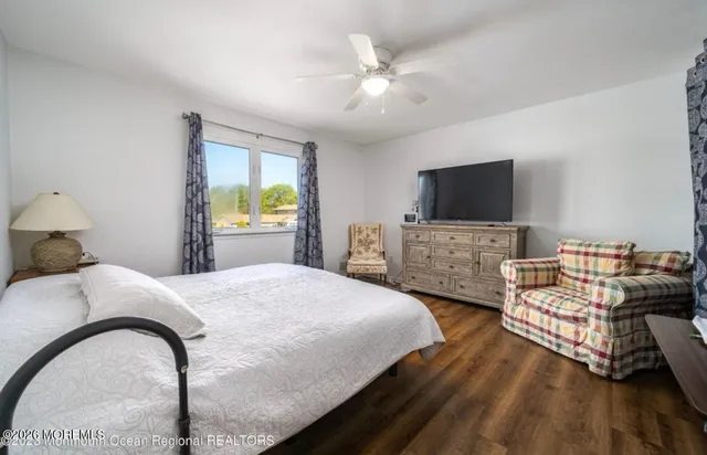 a bedroom with a bed and a flat screen television