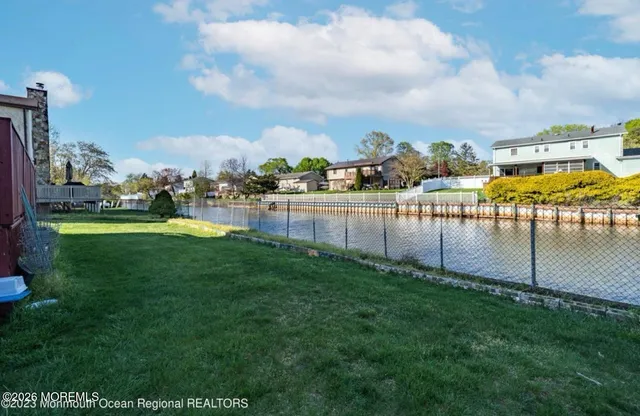 a view of a swimming pool with a garden and lake view