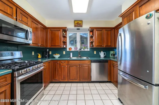 a kitchen with stainless steel appliances granite countertop a stove top oven a sink and dishwasher
